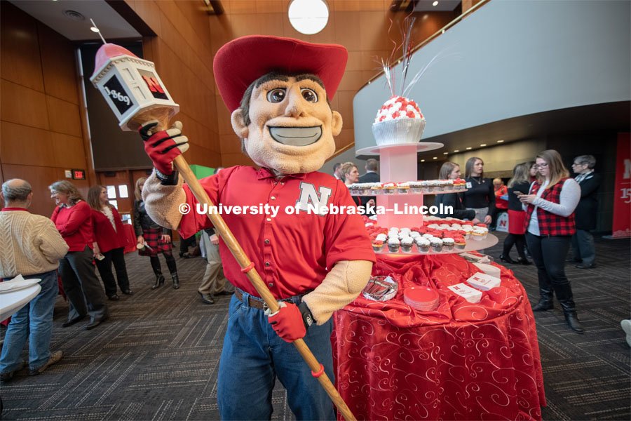 Herbie holds the new mace that was created for the Chancellor to carry at commencement. The mace features the cupola from Love Library along with an ash wood handle. The mace was created at Innovation Campus using a 3D printer and other tools from the UNL makerspace. Everyone was invited to enjoy a cupcake and join in the festivities with their Husker friends at the Wick Alumni Center, Friday February 15th. The Nebraska Charter was available to view, along with other historical items. Copies of Dear Old Nebraska U could be purchased and signed. Charter Day at the Wick Alumni. February 15th, 2019. Photo by Gregory Nathan / University Communication.